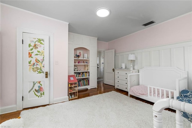 bedroom with visible vents and dark wood-style flooring