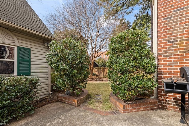 view of yard featuring a patio and fence