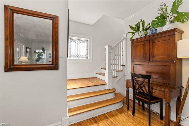 stairway with baseboards and wood finished floors