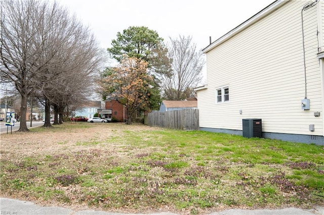 view of yard featuring central AC unit and fence