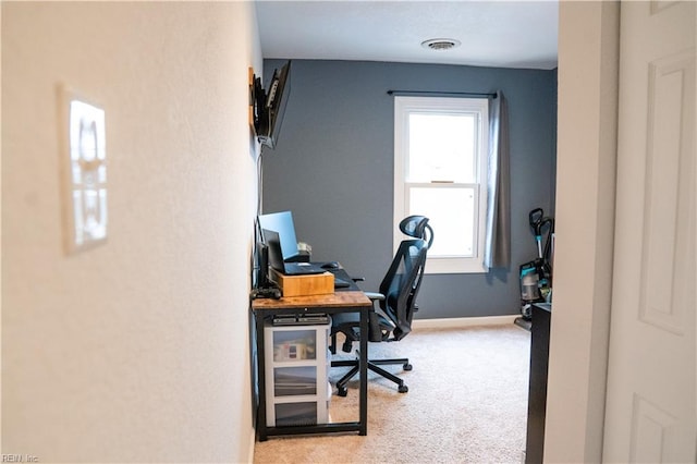 carpeted office space featuring baseboards and visible vents