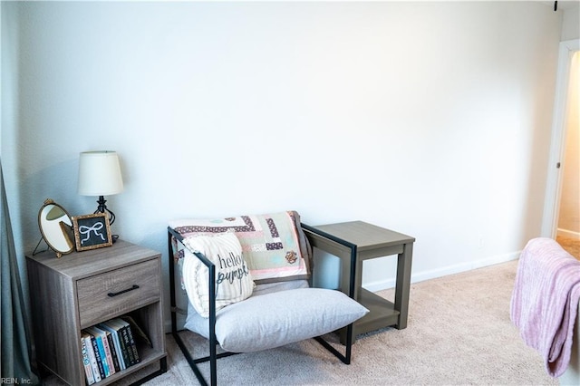 sitting room featuring carpet flooring and baseboards