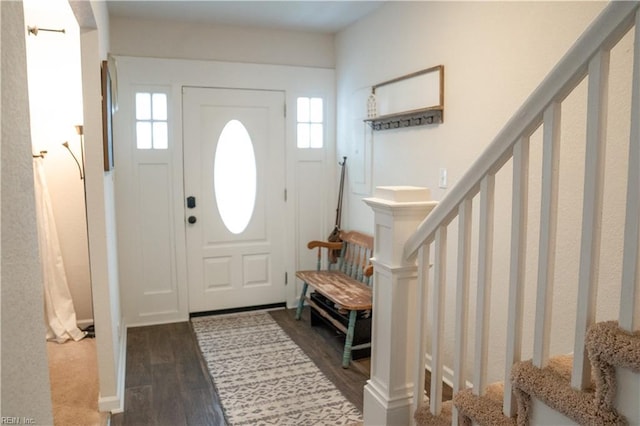 entrance foyer with stairs and dark wood-style floors