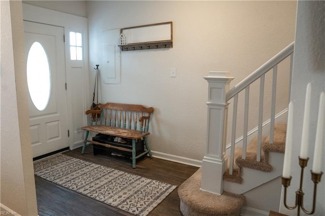 foyer with stairway, baseboards, and wood finished floors