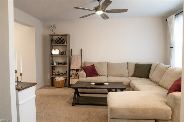 living area with carpet and a ceiling fan