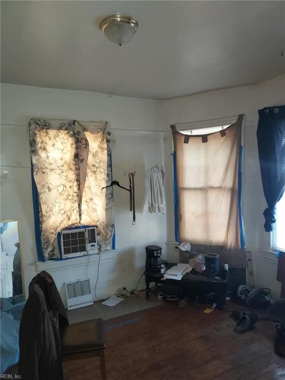 bedroom featuring cooling unit and wood finished floors