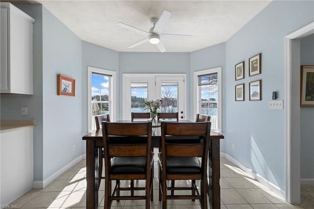 dining room featuring light tile patterned flooring, plenty of natural light, and ceiling fan