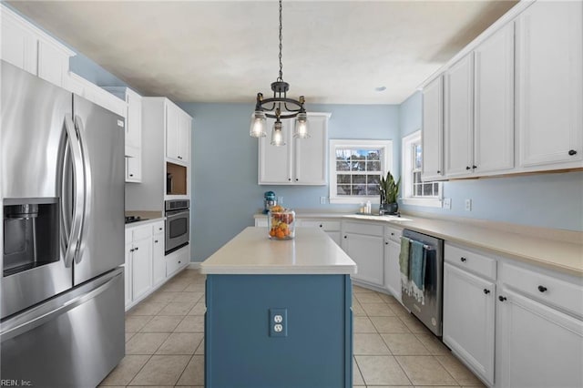 kitchen with white cabinets, light tile patterned floors, and appliances with stainless steel finishes