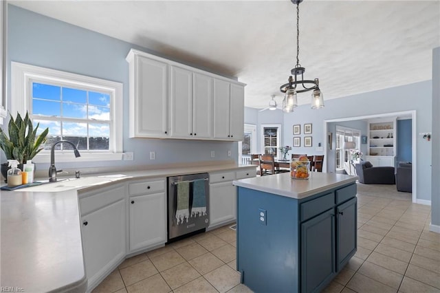 kitchen featuring a sink, stainless steel dishwasher, white cabinets, and light tile patterned floors