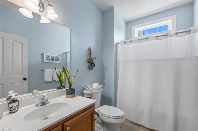 bathroom with tile patterned floors, toilet, a shower with shower curtain, a chandelier, and vanity