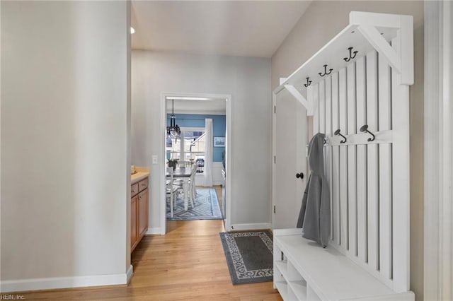 mudroom with baseboards and light wood-style floors