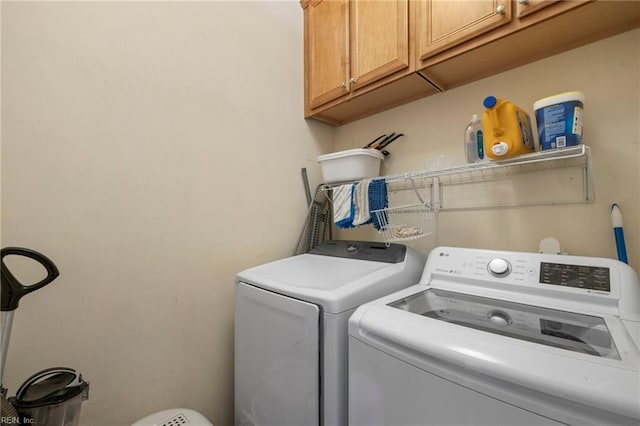 washroom with cabinet space and independent washer and dryer