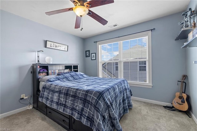 carpeted bedroom with baseboards, visible vents, and ceiling fan