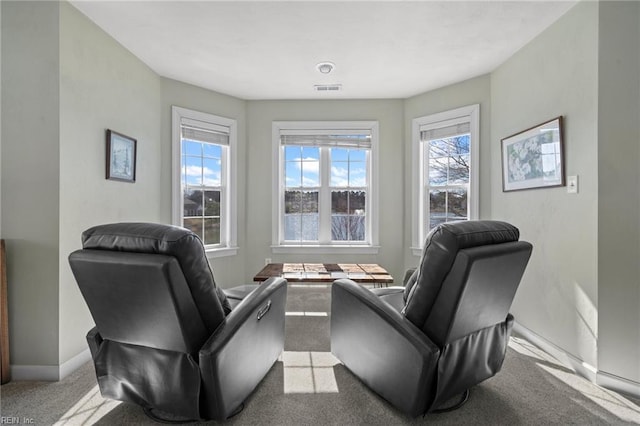 sitting room with visible vents, baseboards, and carpet floors