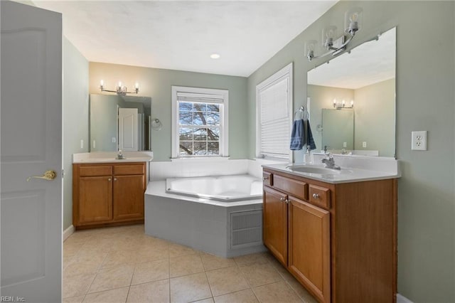 full bath featuring tile patterned flooring, two vanities, a bath, and a sink