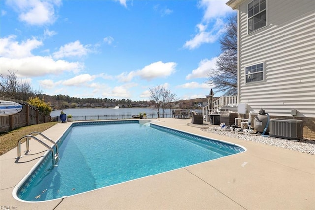 view of swimming pool with a fenced in pool, a water view, fence, central AC, and a patio area