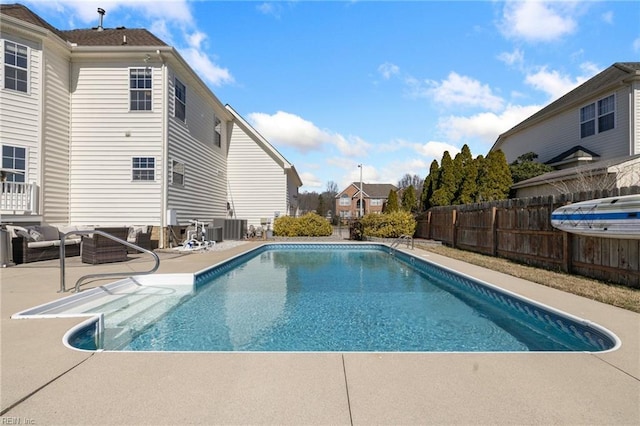 view of swimming pool with a fenced in pool, a fenced backyard, outdoor lounge area, central air condition unit, and a patio area