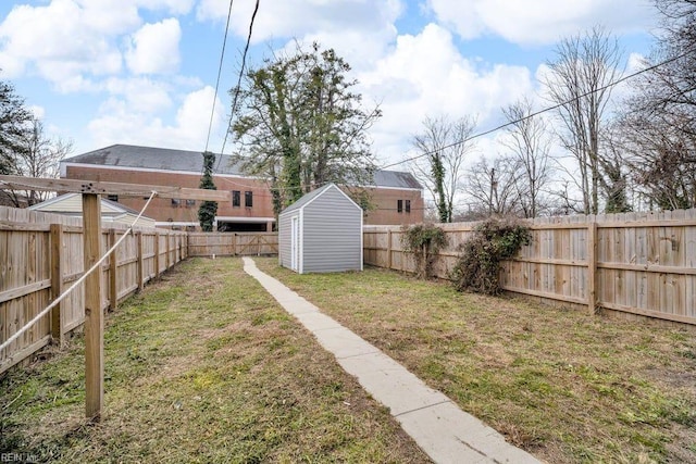 view of yard featuring an outbuilding, a shed, and a fenced backyard