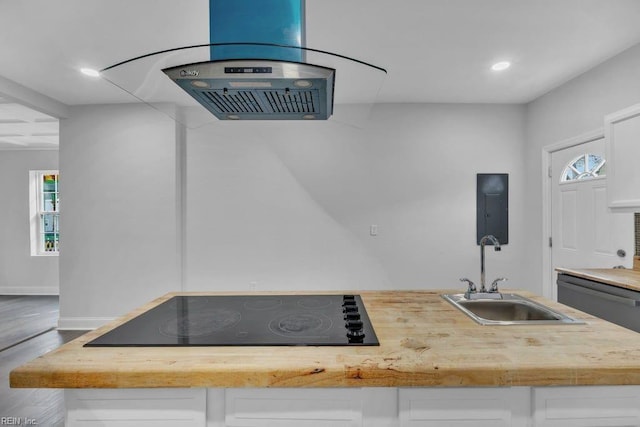 kitchen featuring a wealth of natural light, white cabinets, and black electric stovetop