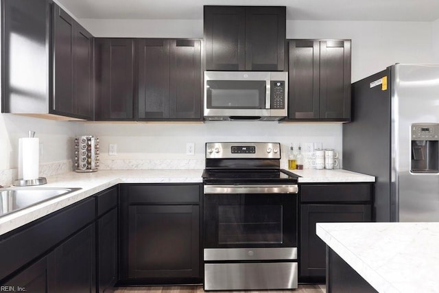 kitchen featuring appliances with stainless steel finishes and light countertops