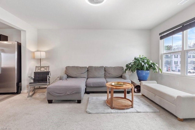 living room featuring visible vents and carpet