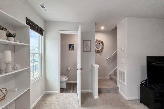 bathroom featuring visible vents, baseboards, and toilet