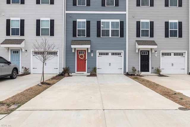 view of property featuring driveway and an attached garage