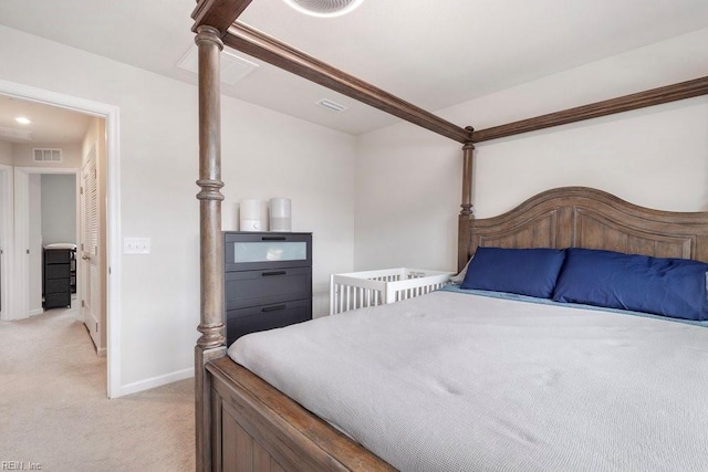 bedroom featuring visible vents, baseboards, and light colored carpet