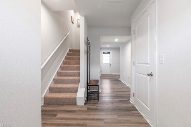 stairs featuring baseboards and wood finished floors