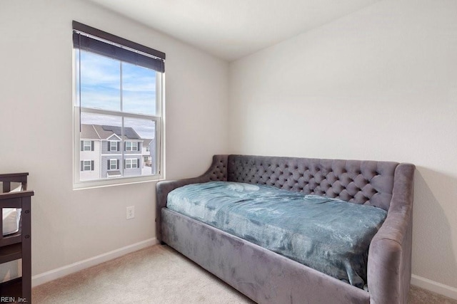 carpeted bedroom featuring baseboards