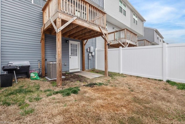 view of yard with central AC unit and fence