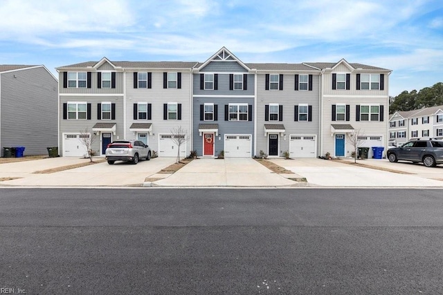 townhome / multi-family property featuring driveway