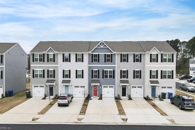 view of property with a garage, driveway, and central AC