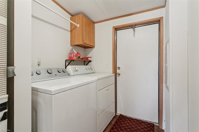 laundry room with washer and dryer, cabinet space, and brick floor