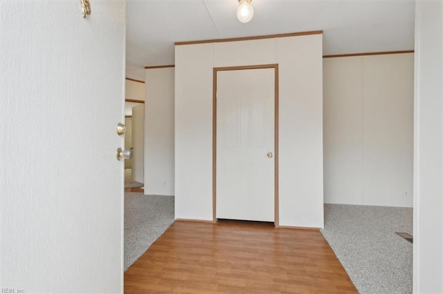 interior space featuring ornamental molding and wood finished floors