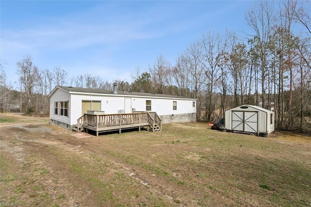 back of house featuring a wooden deck, a lawn, a storage shed, an outdoor structure, and crawl space