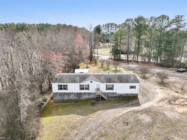 drone / aerial view featuring a view of trees