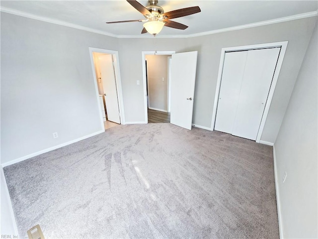 unfurnished bedroom featuring visible vents, baseboards, and crown molding