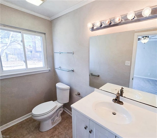 bathroom featuring vanity, baseboards, tile patterned flooring, crown molding, and toilet