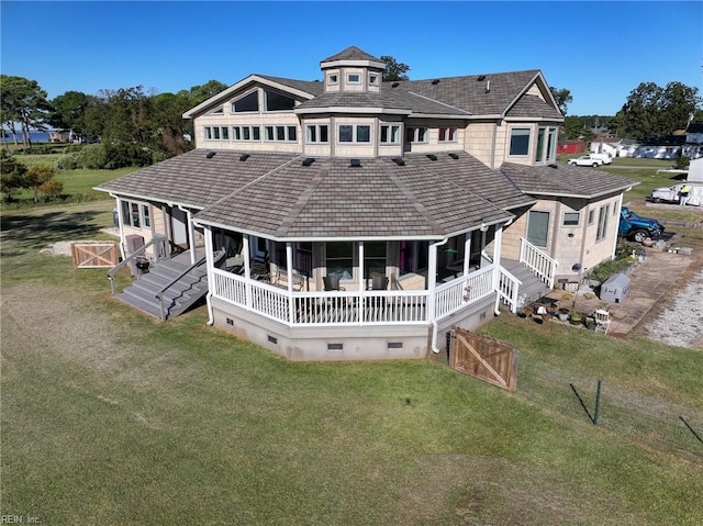 back of property featuring a lawn and crawl space