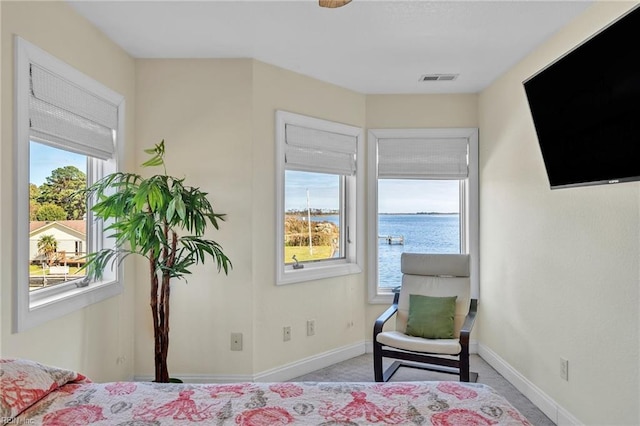 carpeted bedroom featuring visible vents and baseboards