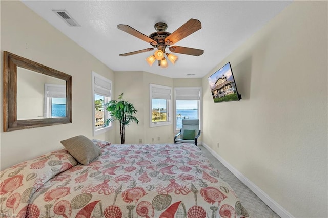 carpeted bedroom featuring visible vents, ceiling fan, and baseboards