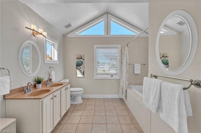 bathroom featuring a sink, visible vents, shower / bath combo with shower curtain, and tile patterned flooring