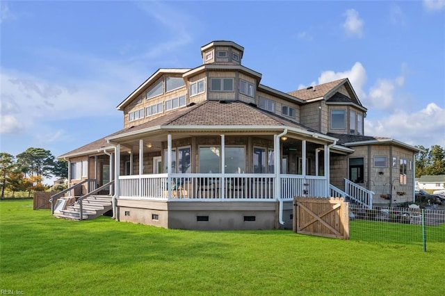 view of front of property featuring crawl space, fence, a front lawn, and a sunroom