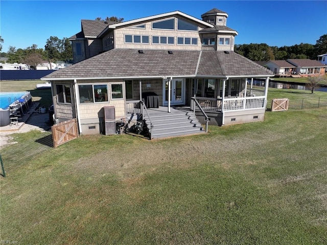 view of front of property featuring crawl space, fence, a front lawn, and a sunroom