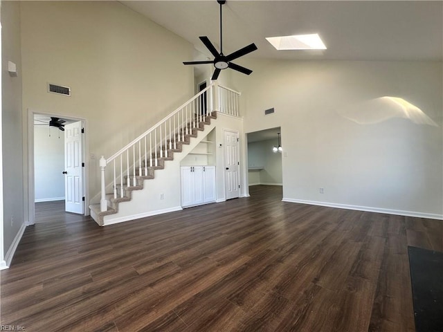 unfurnished living room featuring visible vents, a ceiling fan, dark wood-style floors, stairway, and baseboards