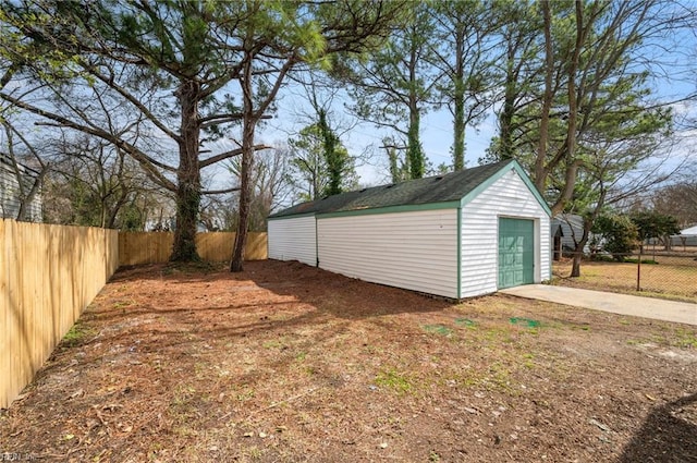 exterior space featuring concrete driveway and fence