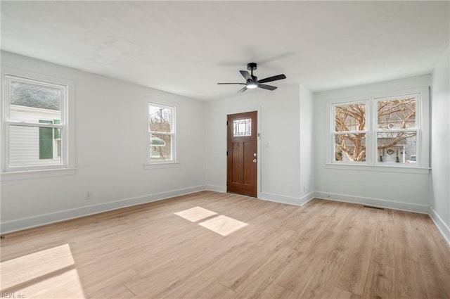 foyer featuring baseboards, ceiling fan, and light wood finished floors