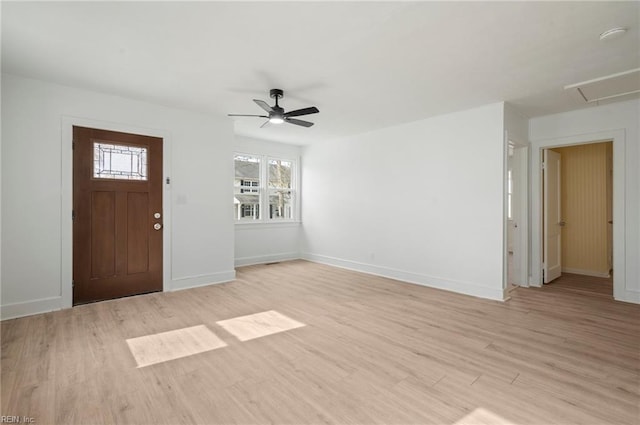 entryway with light wood-style flooring, a ceiling fan, and baseboards