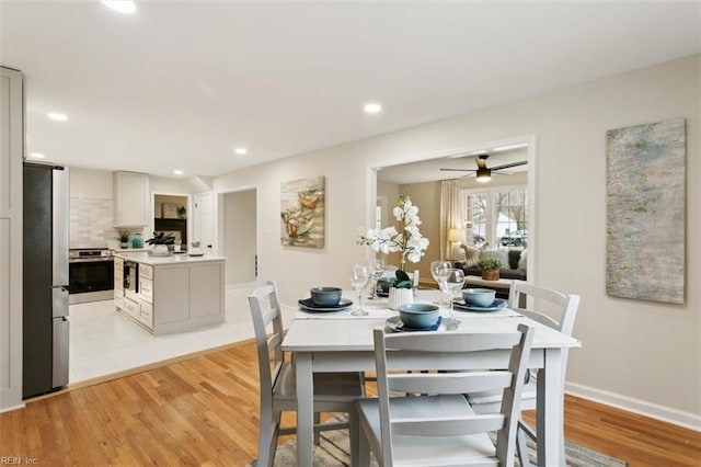 dining room featuring recessed lighting, baseboards, light wood-style floors, and a ceiling fan